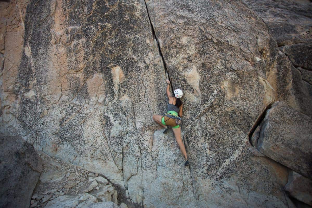 A woman climbing a rock in Banff National Park
