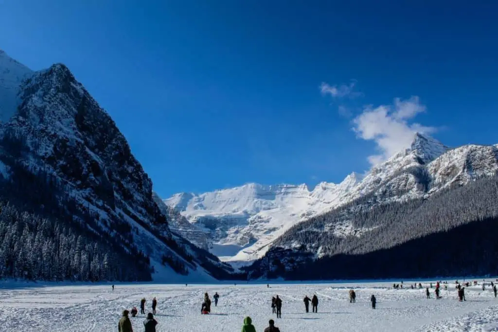 People on the frozen Lake Louise in winter in Banff.