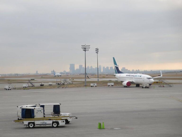 Calgary International Airport YYC with the skyscrapers of downtown Calgary in the background.