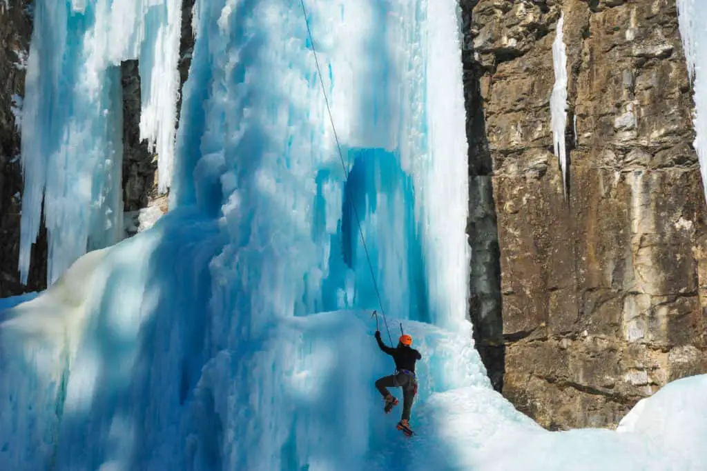 An ice climber on a frozen waterfall in Johnston Canyon