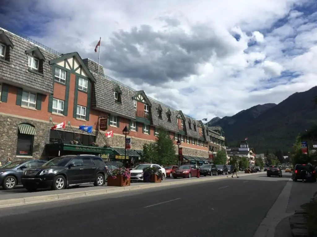 The Mount Royal Hotel on Banff Avenue with the flanks of Sulphur Mountains in the distance.