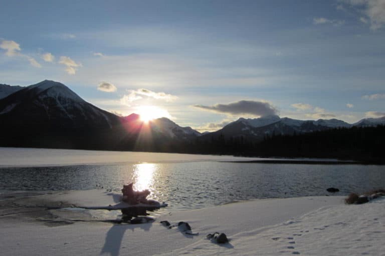 The sun sets behind the Sundance Peak at Vermilion Lakes in Banff