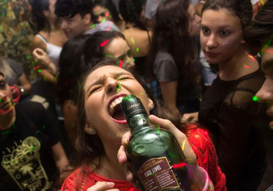 An ecstatic woman drinks during a bachelorette party in Banff