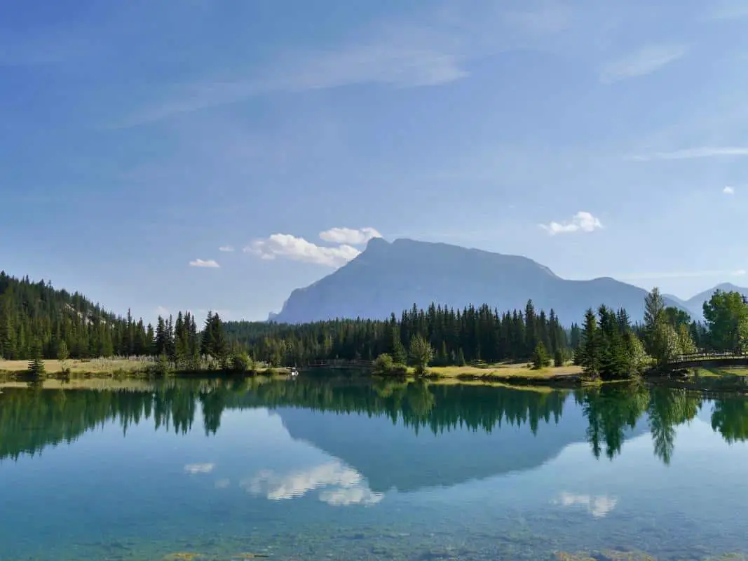 A mountain reflects in Cascade Ponds in Banff National Park