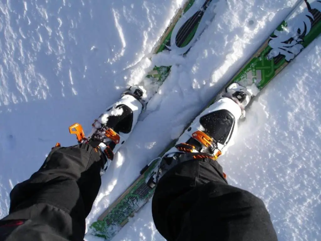 Man seen from above standing on a pair of skis