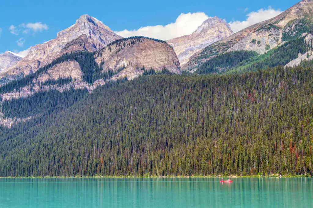 Mount Whyte seen from Lake Louise; a canoe is floating on the water