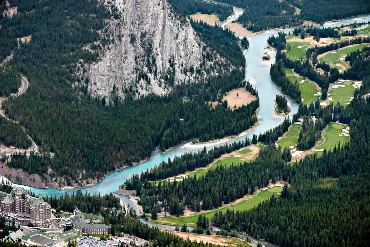 Aerial view of the Banff Springs Golf Course with the Bow River in the middle and Tunnel Mountain on the left