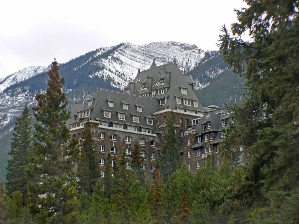 The Fairmont Banff Spring Hotel in Banff between the pine trees of the Canadian Rockies