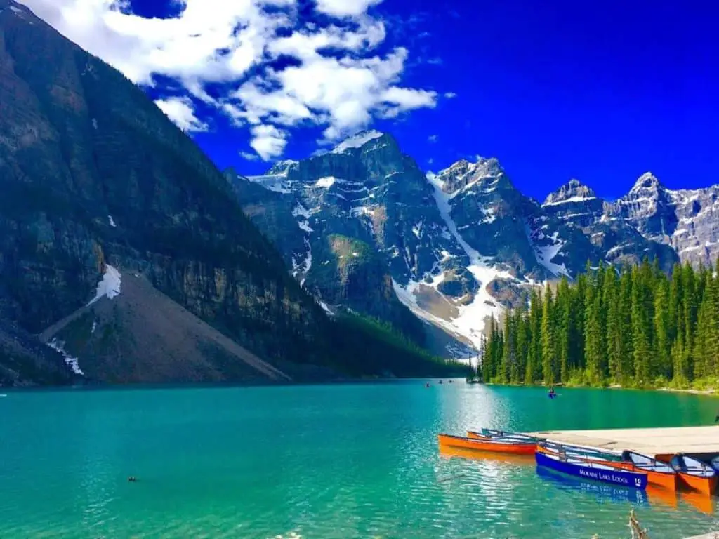 Canoes lie in the water near the Moraine Lake Lodge at Moraine Lake in Banff National Park