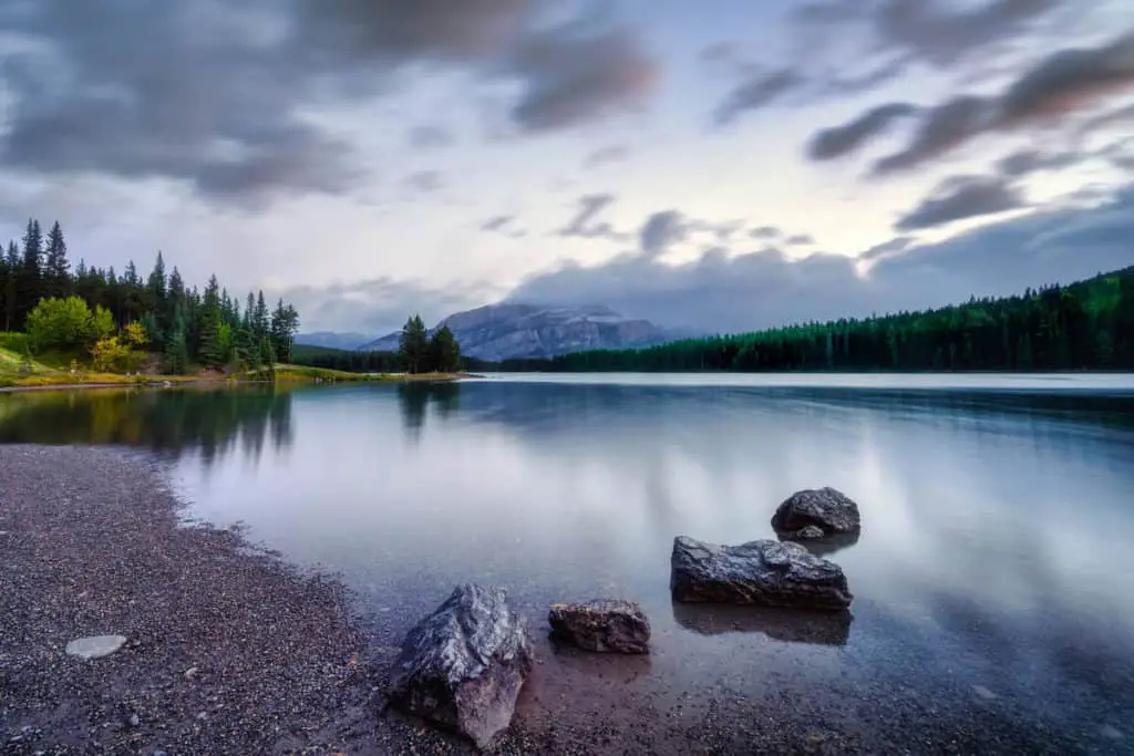 Gorgeous Two Jack Lake in the mist during sunrise at Banff National Park