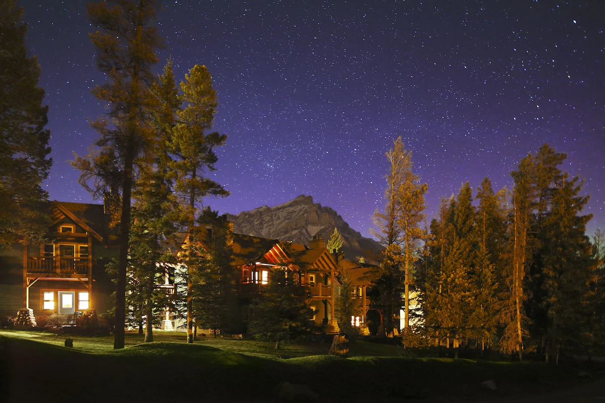 The Buffalo Mountain Lodge in Banff at night with Cascade Mountain in the background