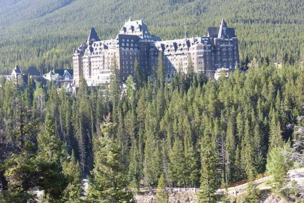 The Banff Springs Hotel between the pine trees on the slopes of Sulphur Mountain in Banff