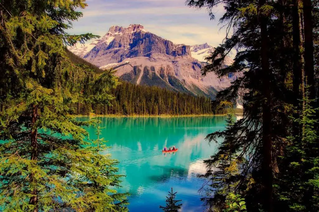 A canoe floats on the turquoise-colored water of Emerald Lake in Yoho National Park
