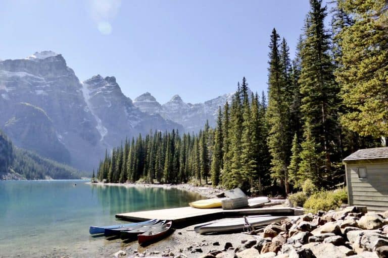 Canoes at the dock at Moraine Lake under a clear summer sky