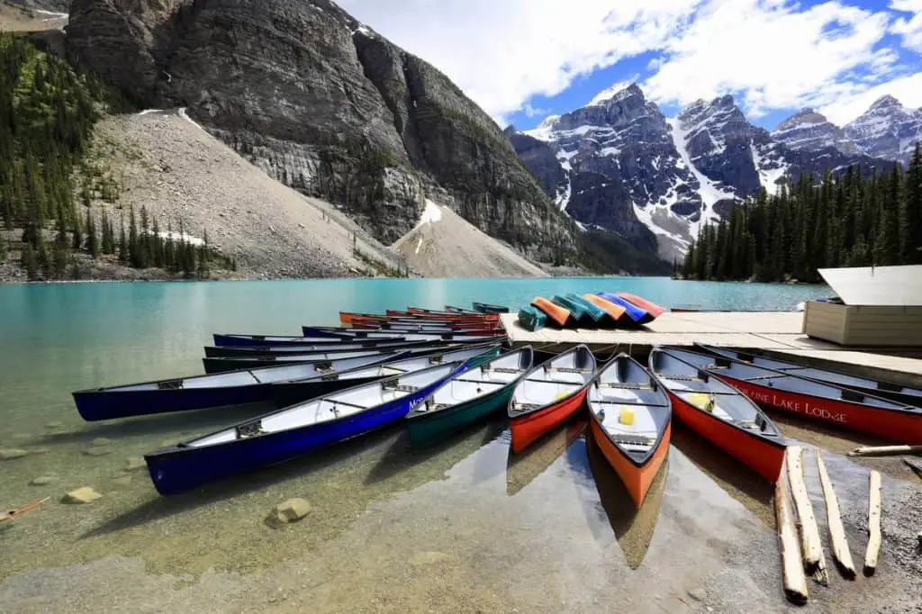 Multiple canoes at the dock at Moraine Lake in Banff National Park