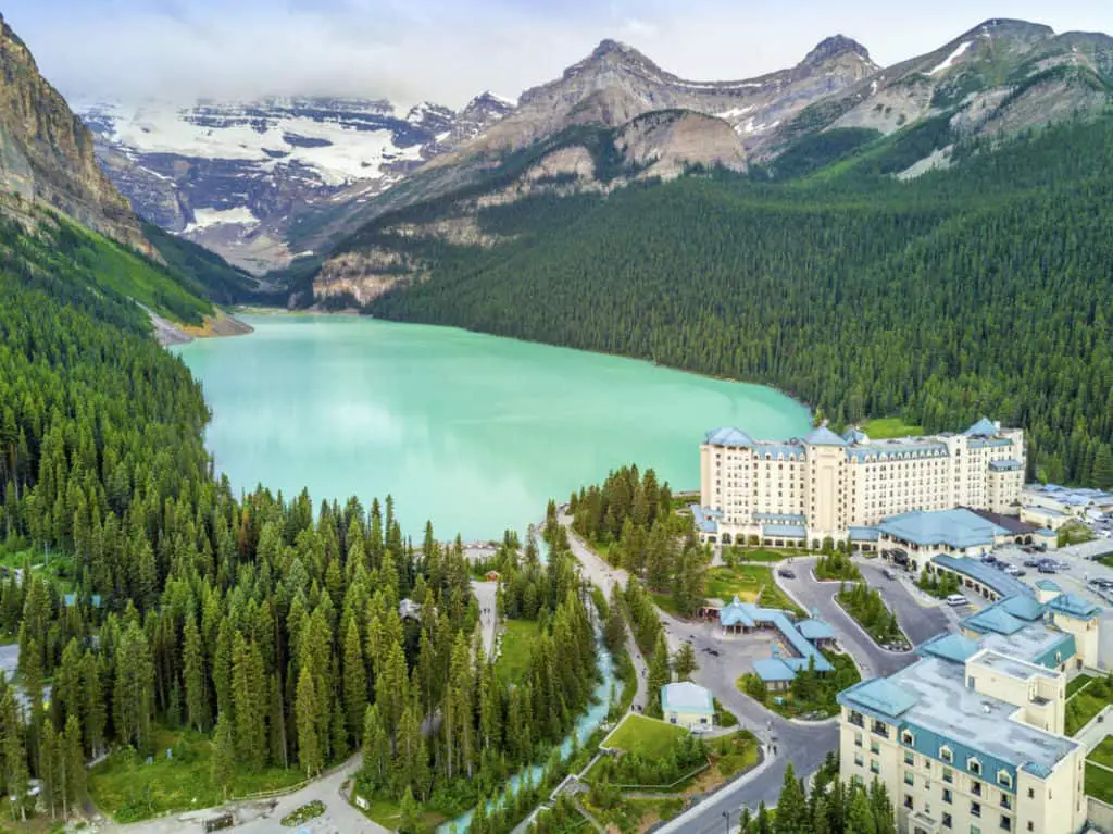 Aerial view of Château Lake Louise in the Canadian Rockies with the lake's striking turquoise color dominating the landscape