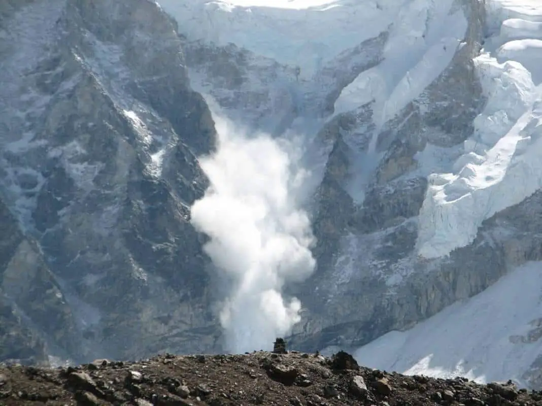 An avalanche violently rolls down a mountain slope in Banff National Park