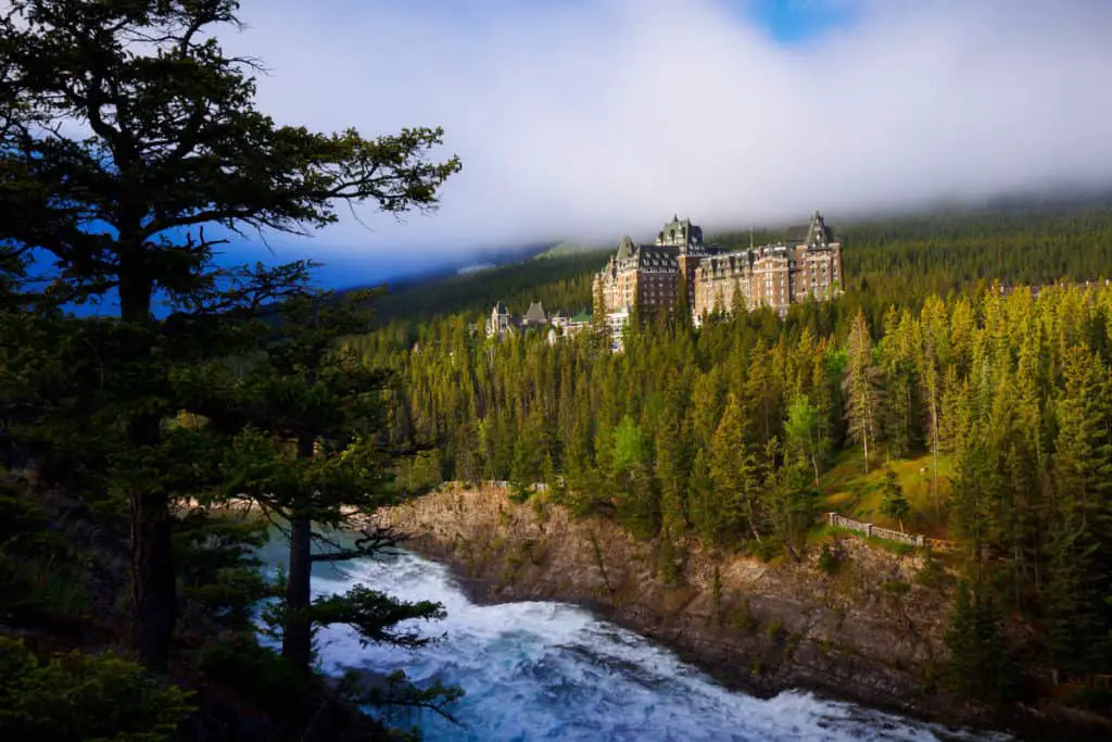 The Banff Springs Hotel, seen from Surprise Corner, rises from the trees in the fall