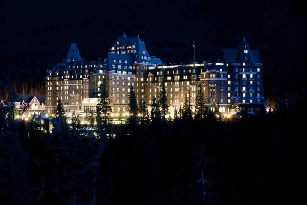 The Banff Springs Hotel at night with hundreds of lights glowing from the windows 