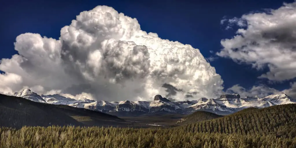 Storm clouds above the pointy silhouettes of the Rocky Mountains of Banff National Park