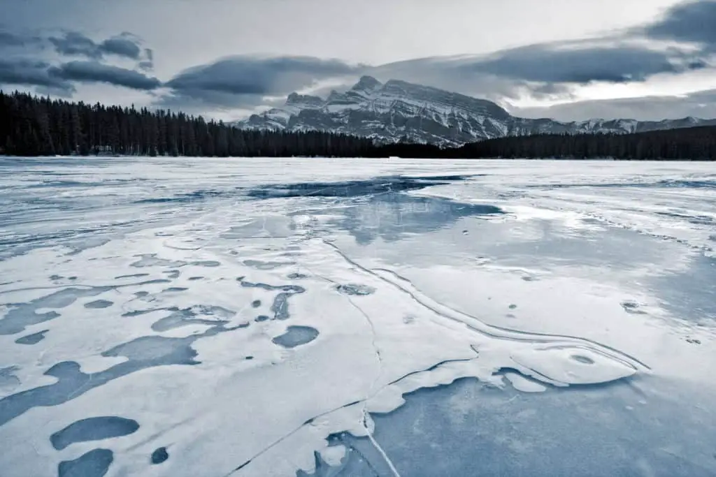 A frozen Two Jack Lake on a cloudy winter day