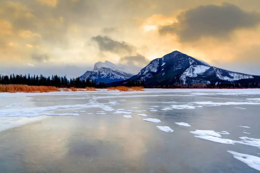A freshly frozen Vermilion Lakes near the town of Banff with Mount Rundle in the background on a cold, overcast morning just before sunrise.