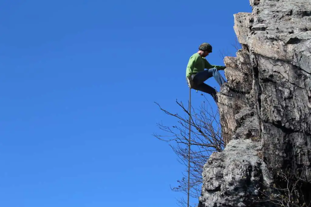 A man is climbing a rock in Banff National Park