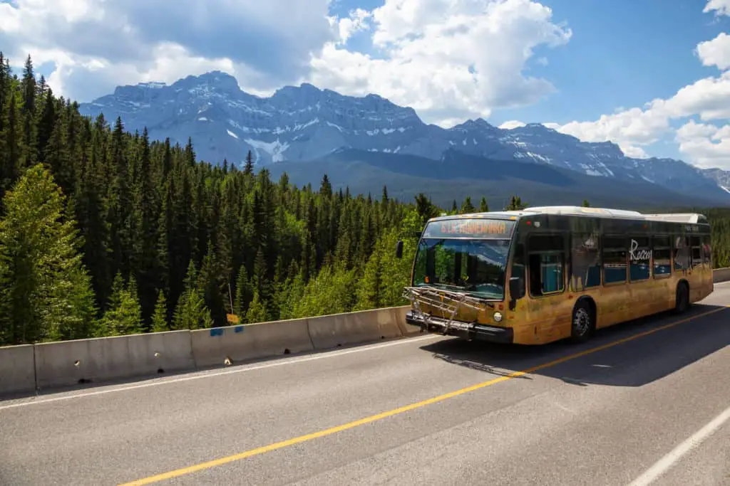 A bus of public transport company Roam Transit drives near Lake Minnewanka in Banff National Park