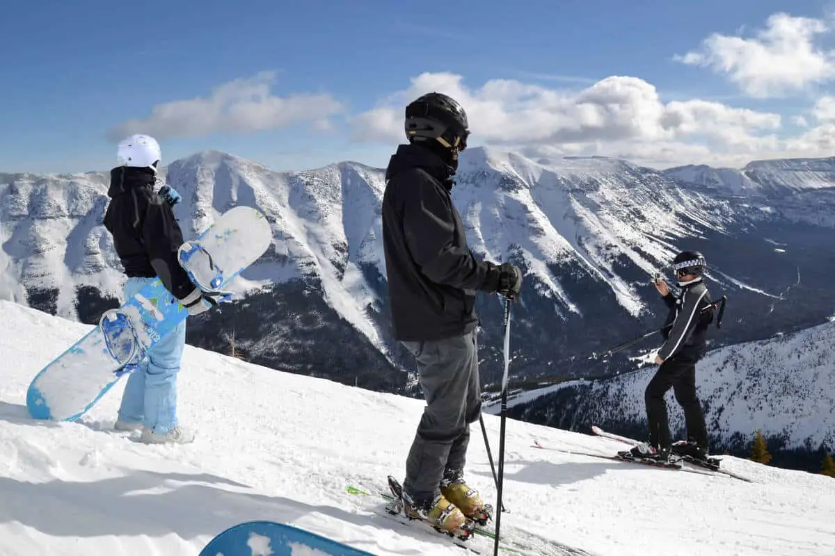 Snowboarders overlooking the Rockies on a slope of the Lake Louise Ski Resort