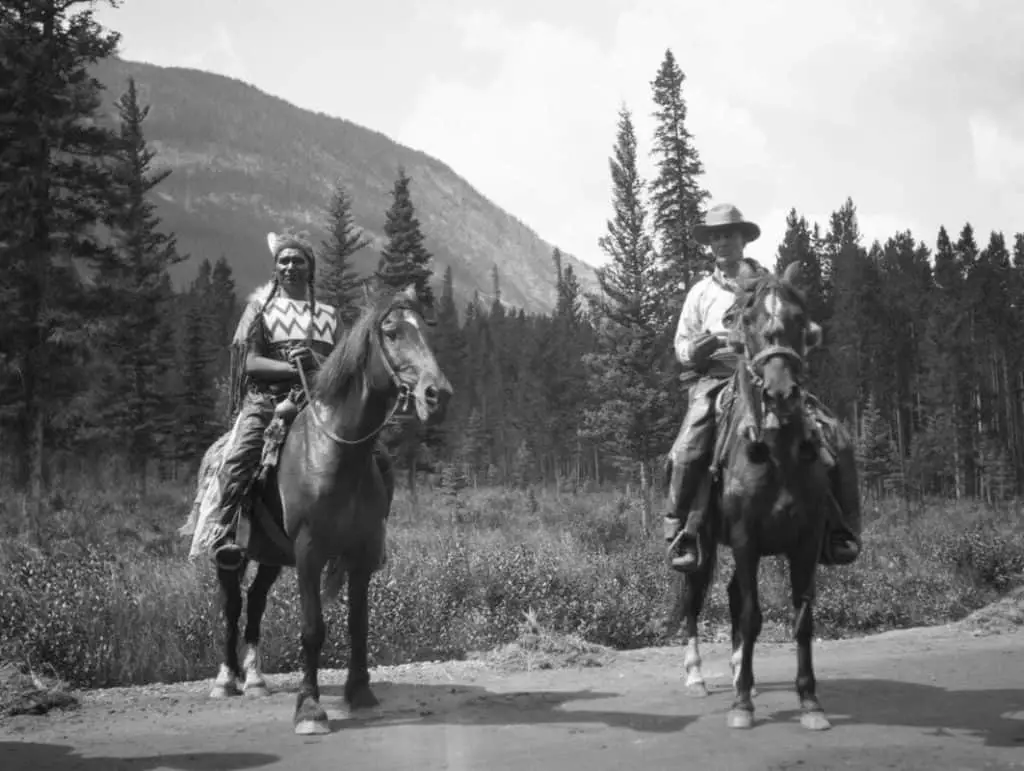 Enos Hunter (left) and Norman Luxton (right) on a horse during the Banff Indian Days
