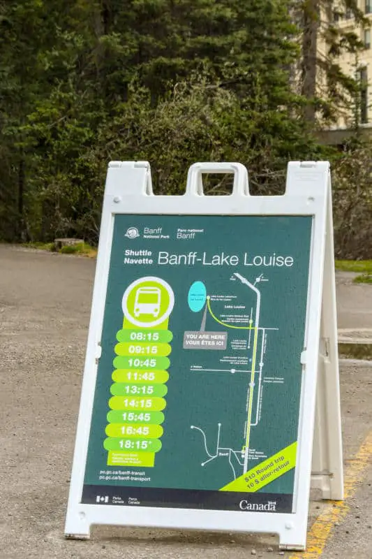 A sign at the Lake Louise parking lot depicting the Parks Canada shuttle bus schedule