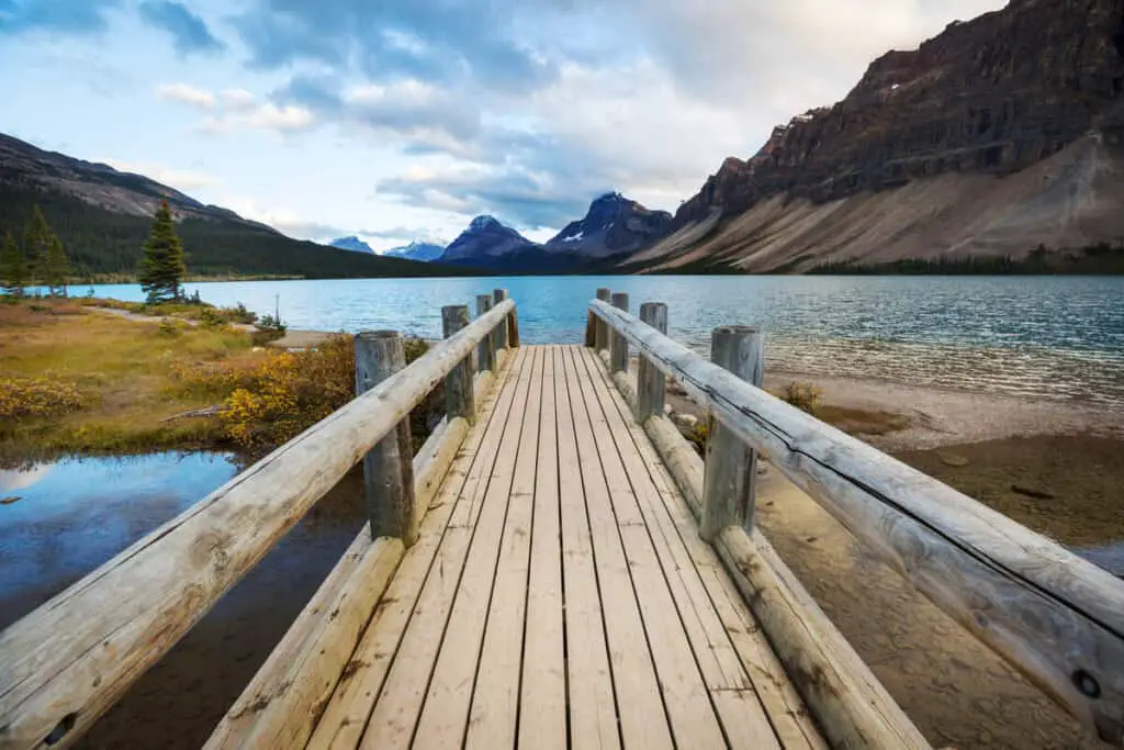 View over Bow Lake from a wooden bridge that leads up to the lakeshore
