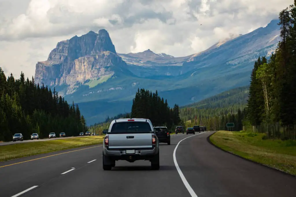 A pickup trick travels across the Trans-Canada Highway in Banff National Park near Castle Mountain