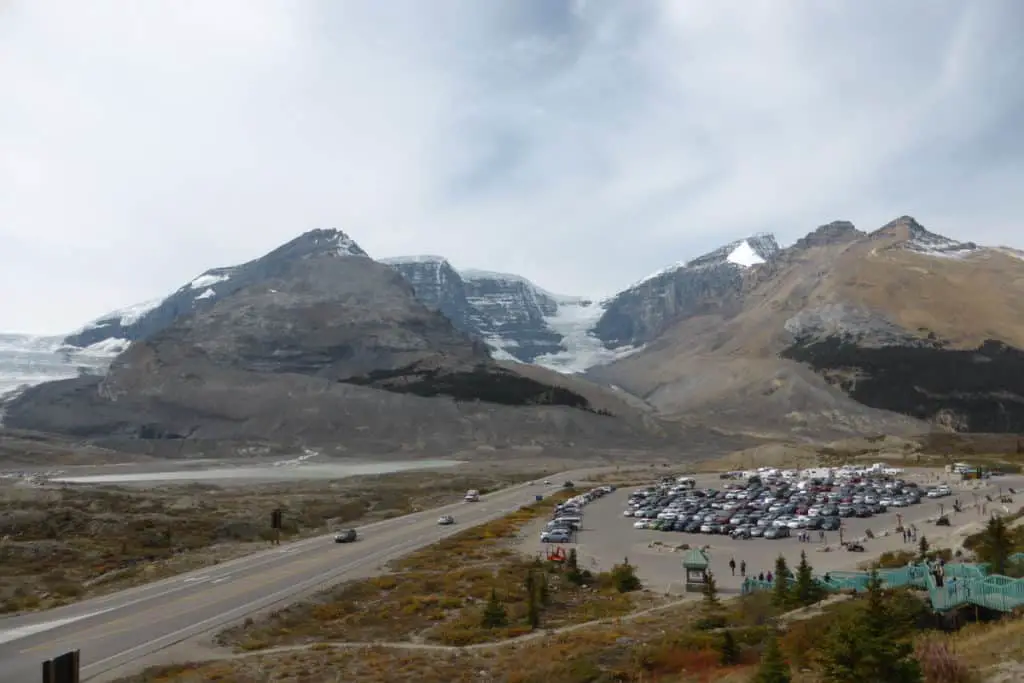The Columbia Icefield with in the foreground the parking lot of the Columbia Icefield Discovery Centre