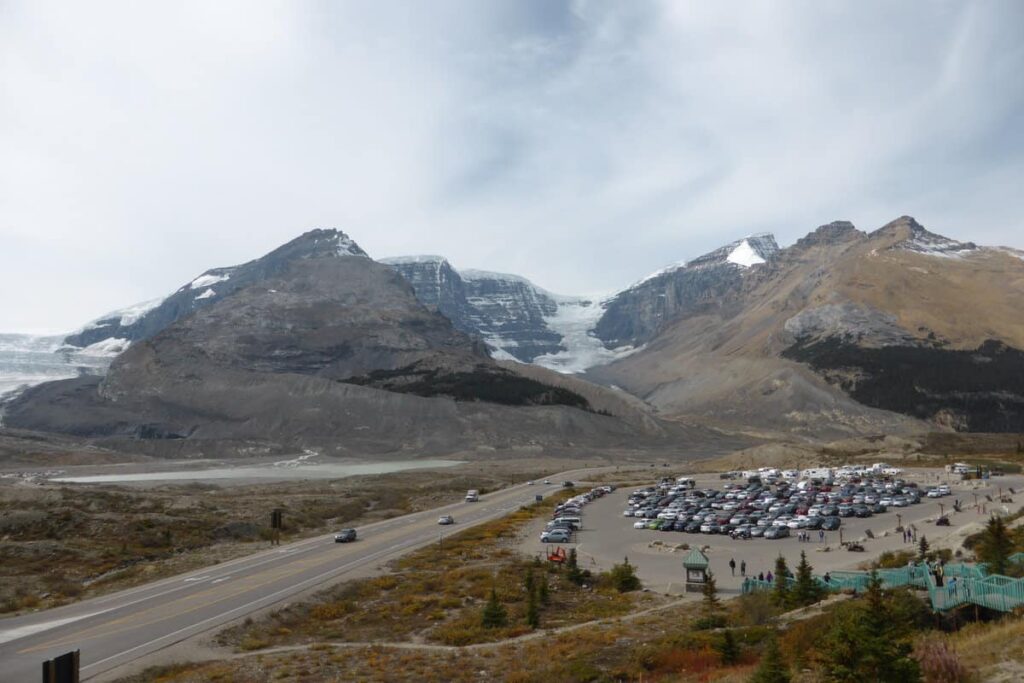 The Columbia Icefield with in the foreground the parking lot of the Columbia Icefield Discovery Centre