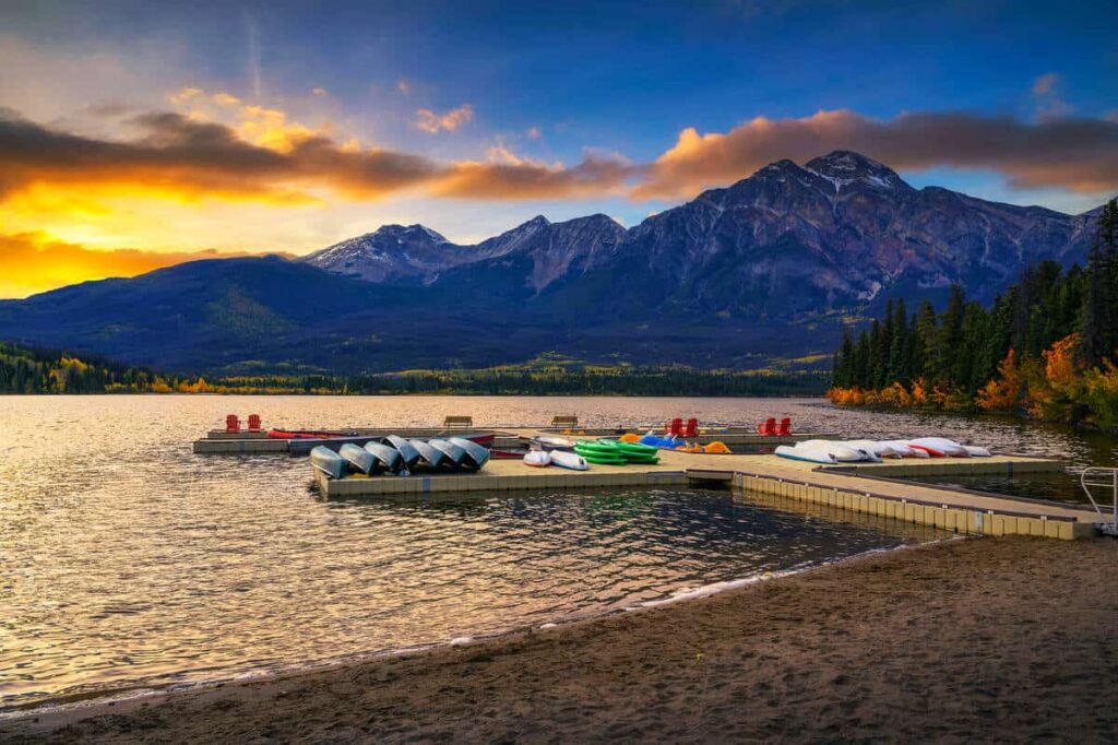 Canoes lying on a jetty on Pyramid Lake at sunset in Jasper National Park