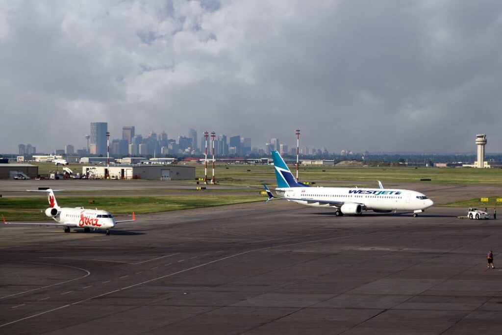 Aircraft at Calgary International Airport (YYC) with the skyline of Calgary in the background