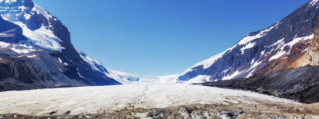 Frontal shot of the Athabasca Glacier, wedged between two mountain peaks in Jasper National Park