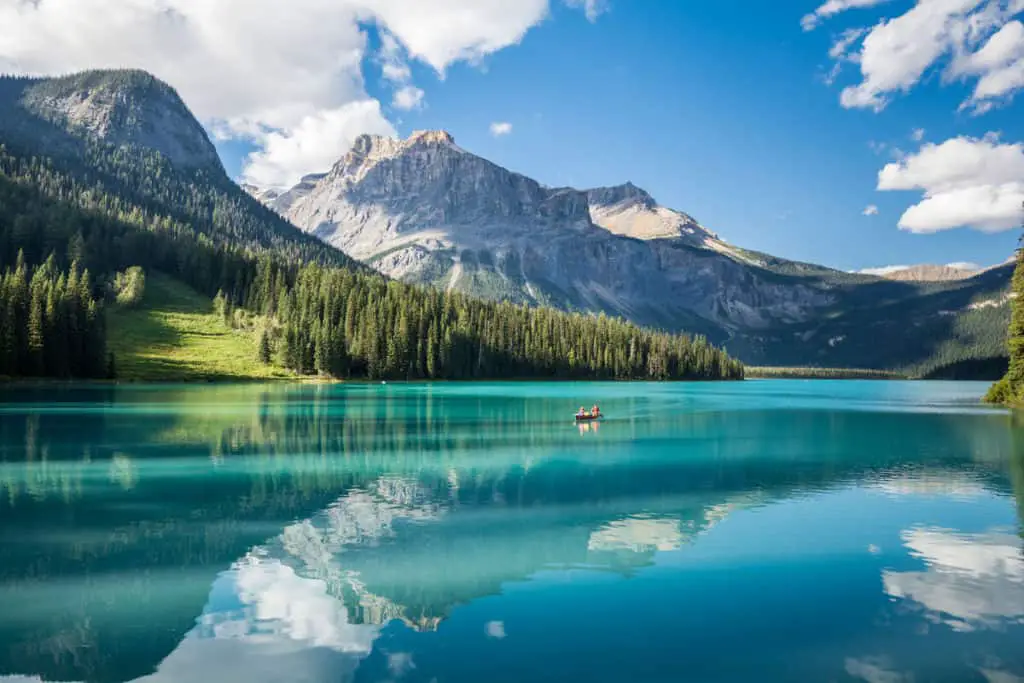 Emerald Lake in Yoho National Park with a canoe carrying two people on the striking turquoise waters