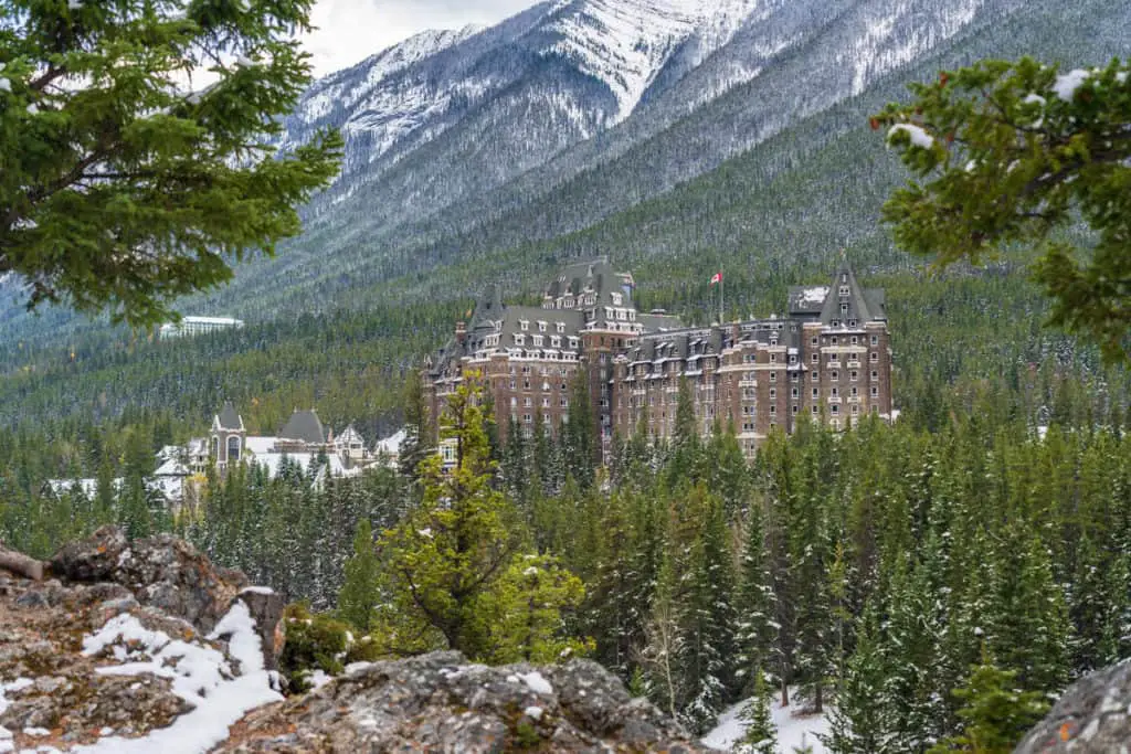 The historical Banff Springs Hotel, rising from the ubiquitous pine trees on the flanks of Sulphur Mountain in Banff National Park