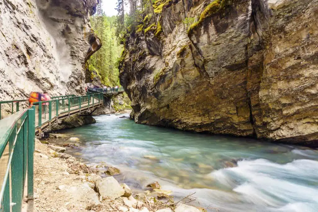 The boardwalk through Johnston Canyon in Banff National Park with a fast flowing river passing below