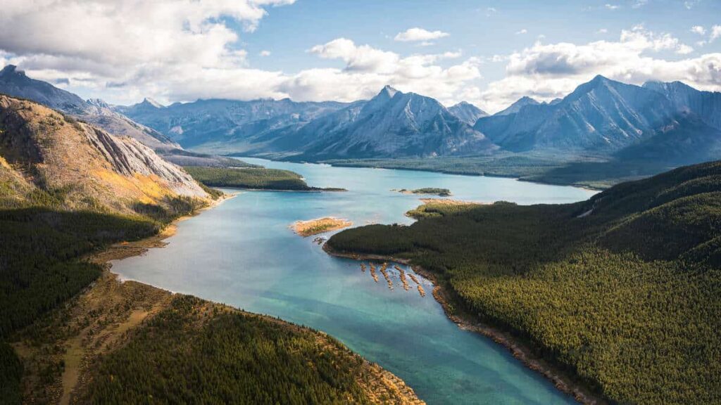 View from a helicopter over a lake and the surrounding mountains in Mount Assiniboine National Park in British Columbia