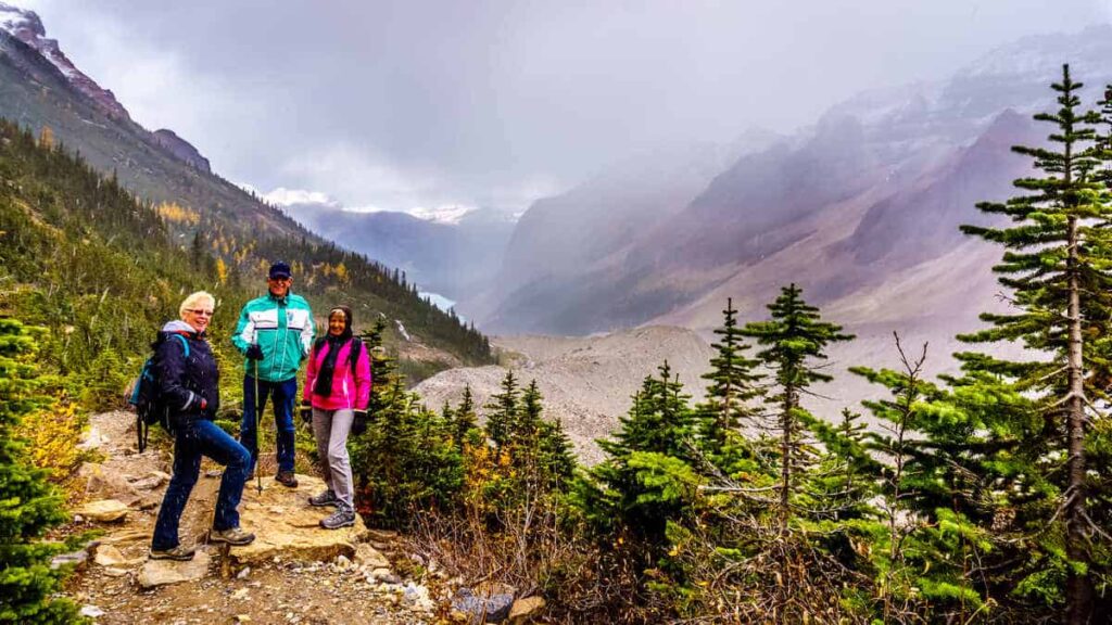 Three seniors hiking near the Plain of the Six Glaciers near the Lake Agnes Tea House