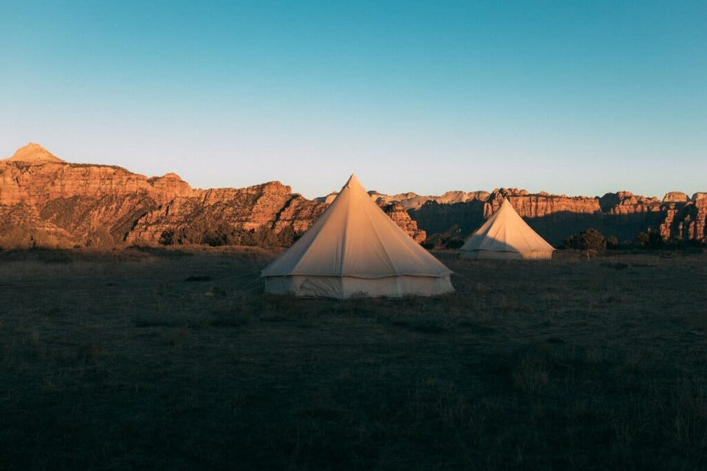 A glamping tent out in the field in Zion National Park during sunset over Utah, United States