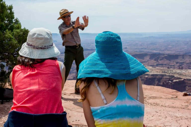 An NPS park ranger explaining two tourists something in Grand Canyon National Park.